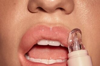 girl applying product to solve chapped lips issue.