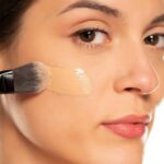 Women applying foundation in proper way to get rid of oxidation.