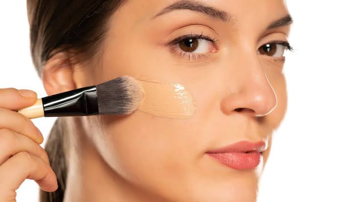 Women applying foundation in proper way to get rid of oxidation.