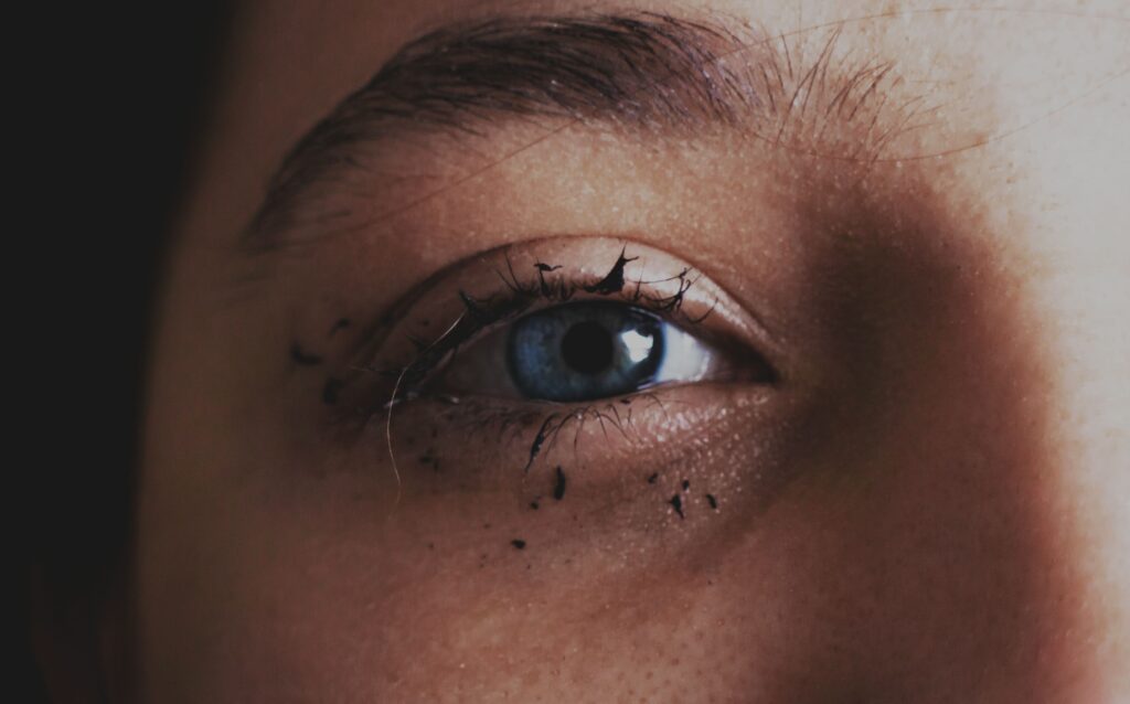 Mascara applied on girls eye brows.