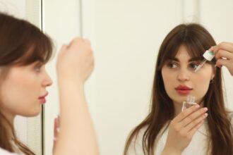 Girl applying serum in correct method to avoid mulling.