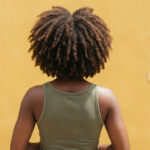 Close-up of defined, healthy coily hair.
