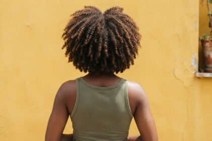 Close-up of defined, healthy coily hair.